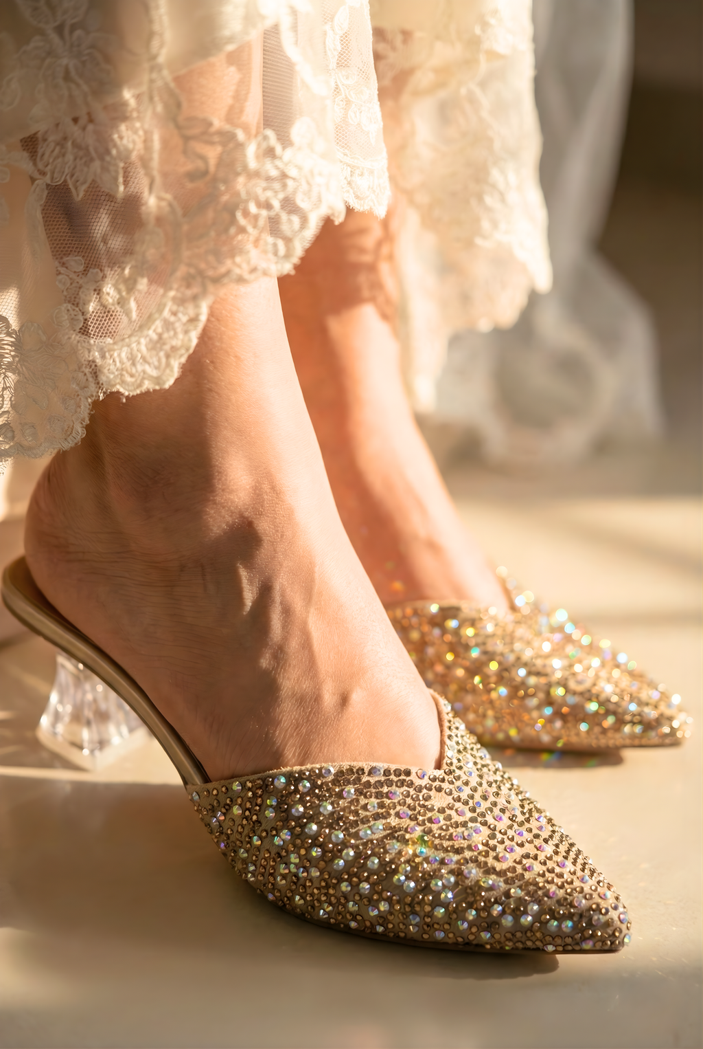 Gold embellished shoes worn with a white lace dress.