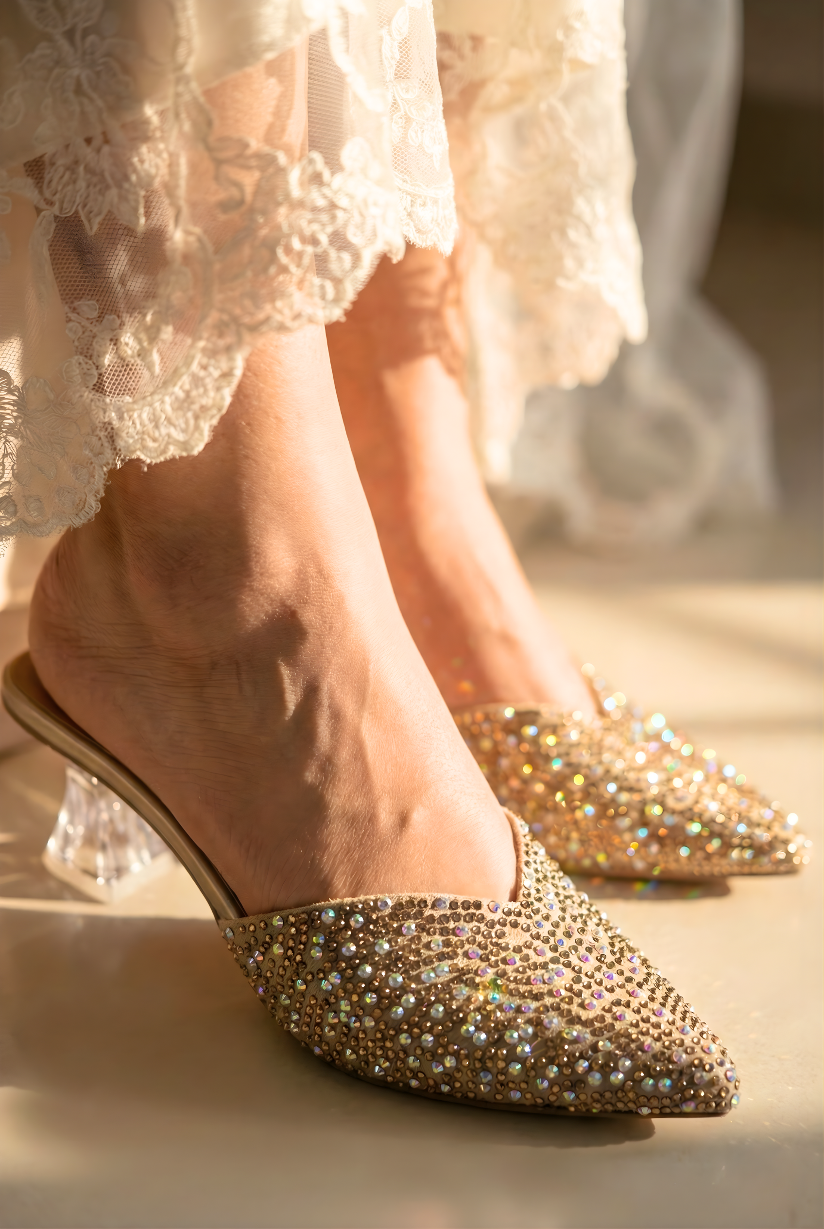 Gold embellished shoes worn with a white lace dress.