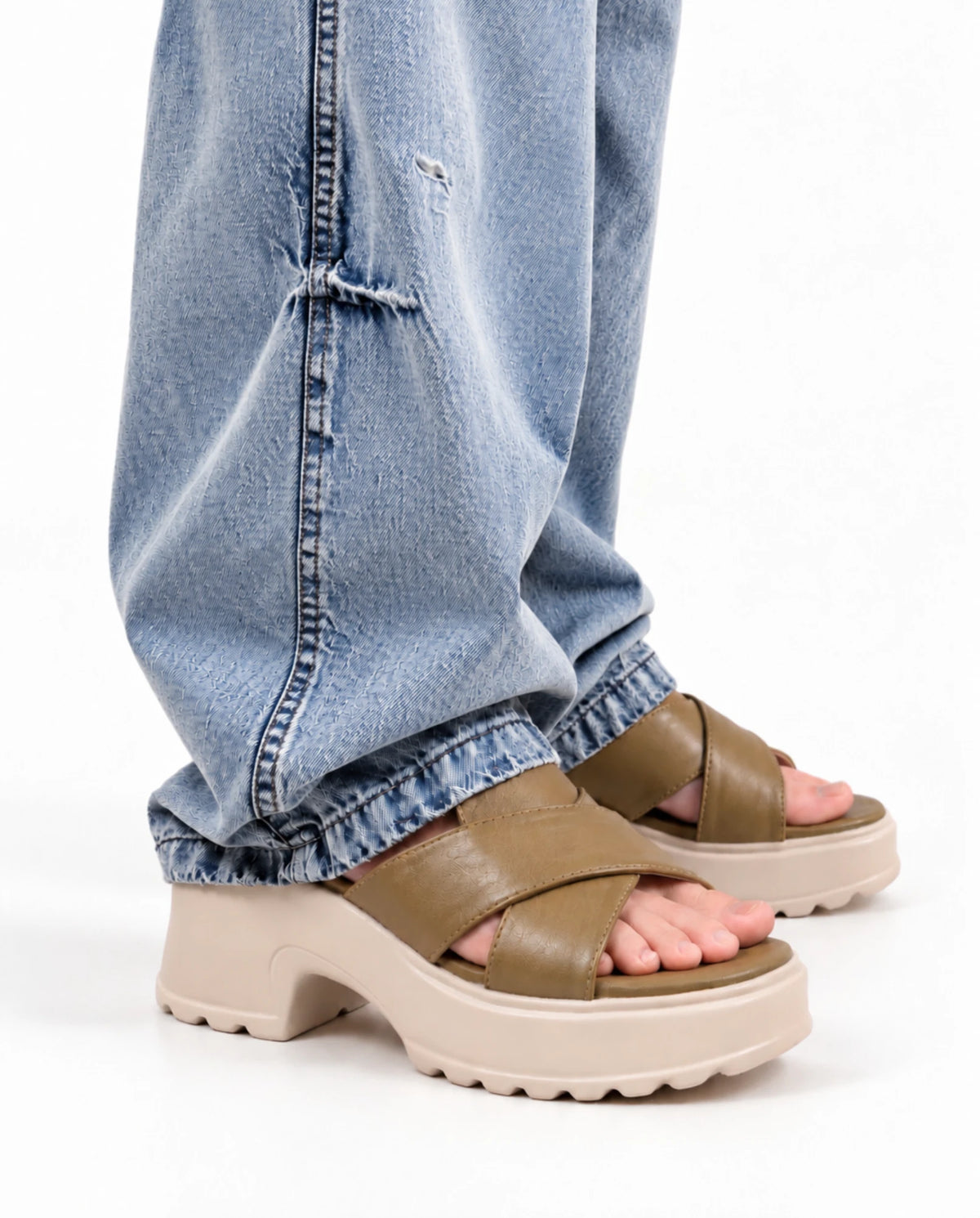Side view of olive platform heels worn with jeans