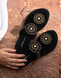 Black women’s flat slides with gold bead medallion design, crystal accents, toe-loop strap and low comfortable heel