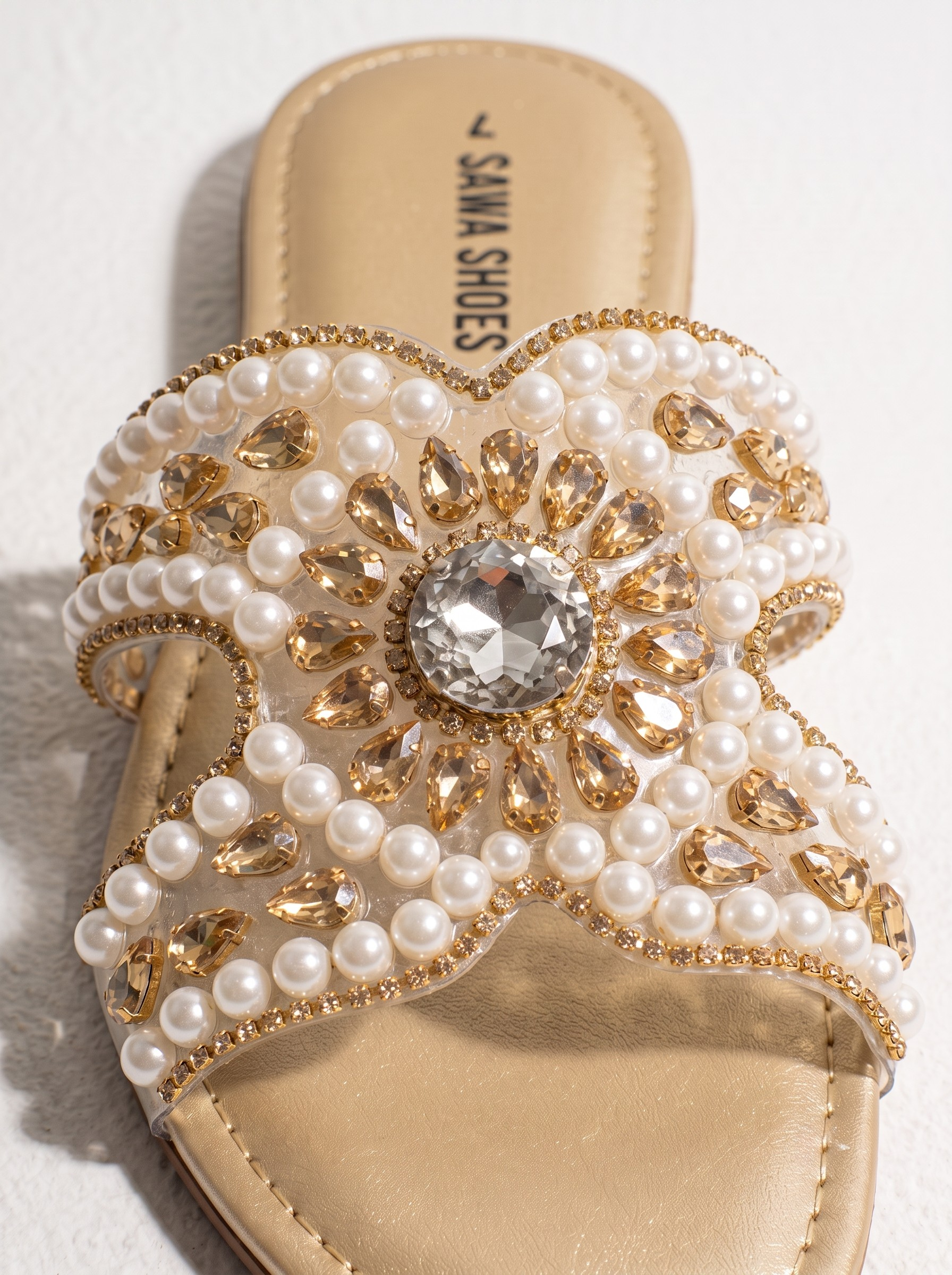 Beige women’s flat slides with clear upper, pearl beads, gold stones, crystal centerpiece and cushioned sole