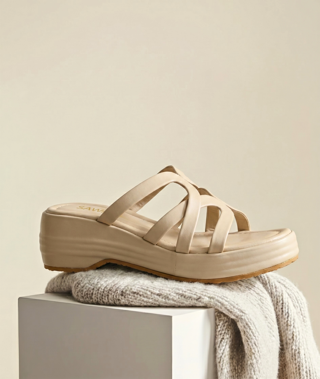 Beige sandal on a light gray surface with a beige background