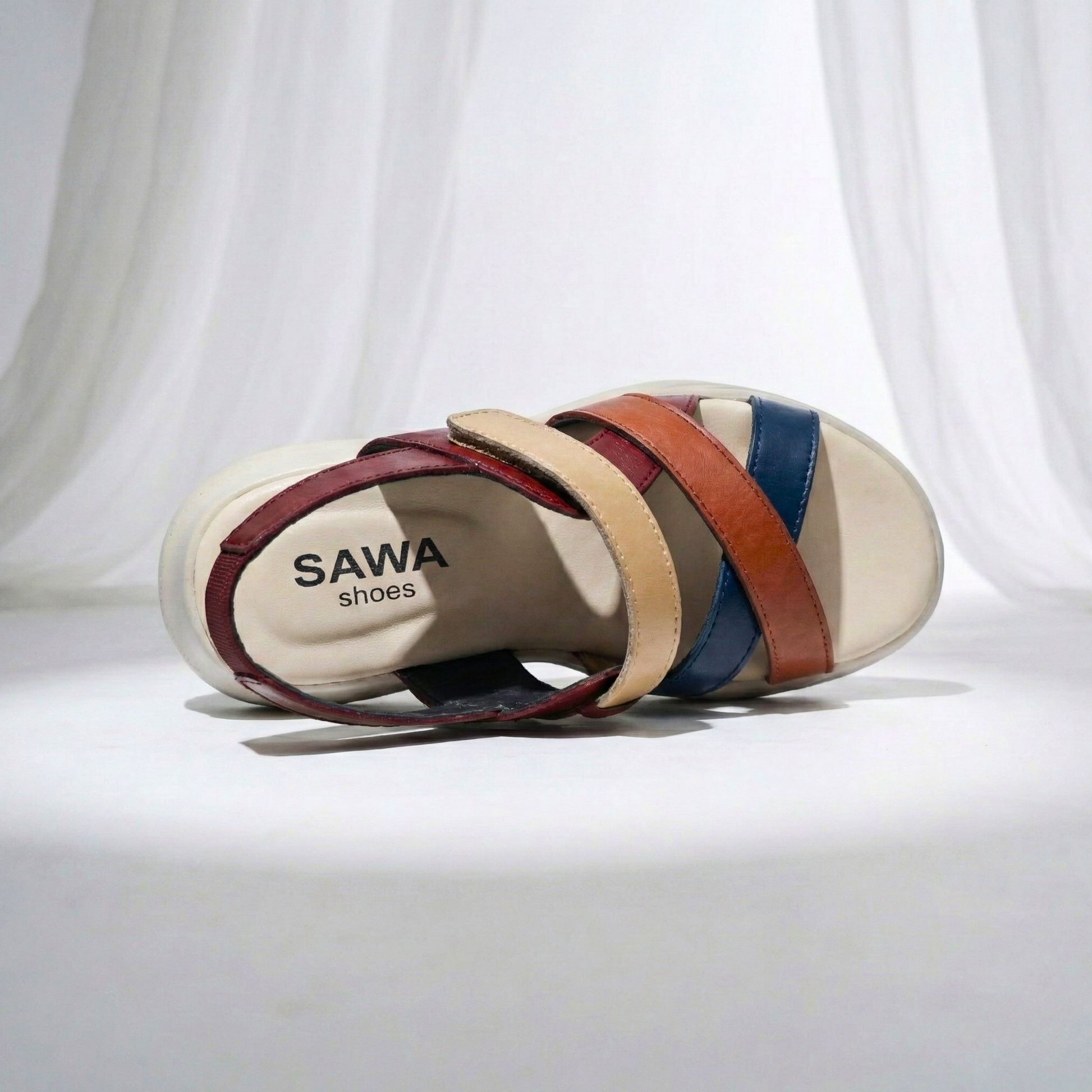 Multicolored sandal with 'SAWA shoes' branding on a white background