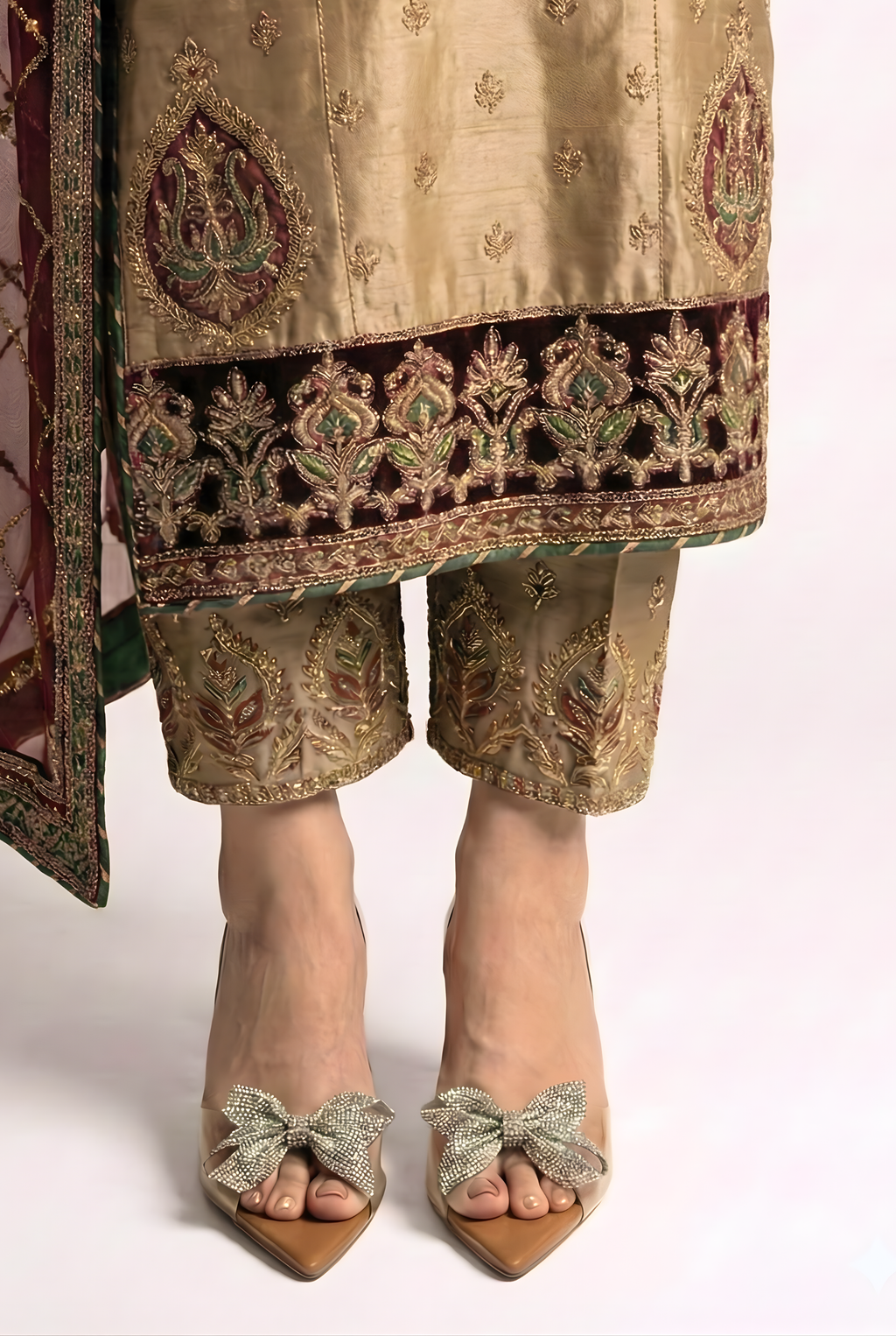 Close up of fancy transparent vinyl sandals with rhinestone bow and sculpted crystal geometric heel on white background