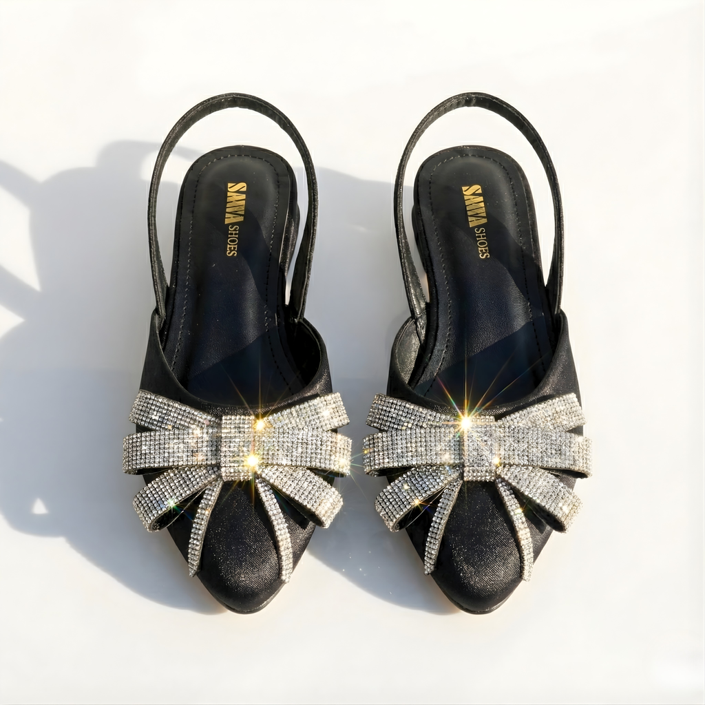 Black satin pointed-toe slingback flats with sparkling rhinestone crystal bow by SAWA Shoes