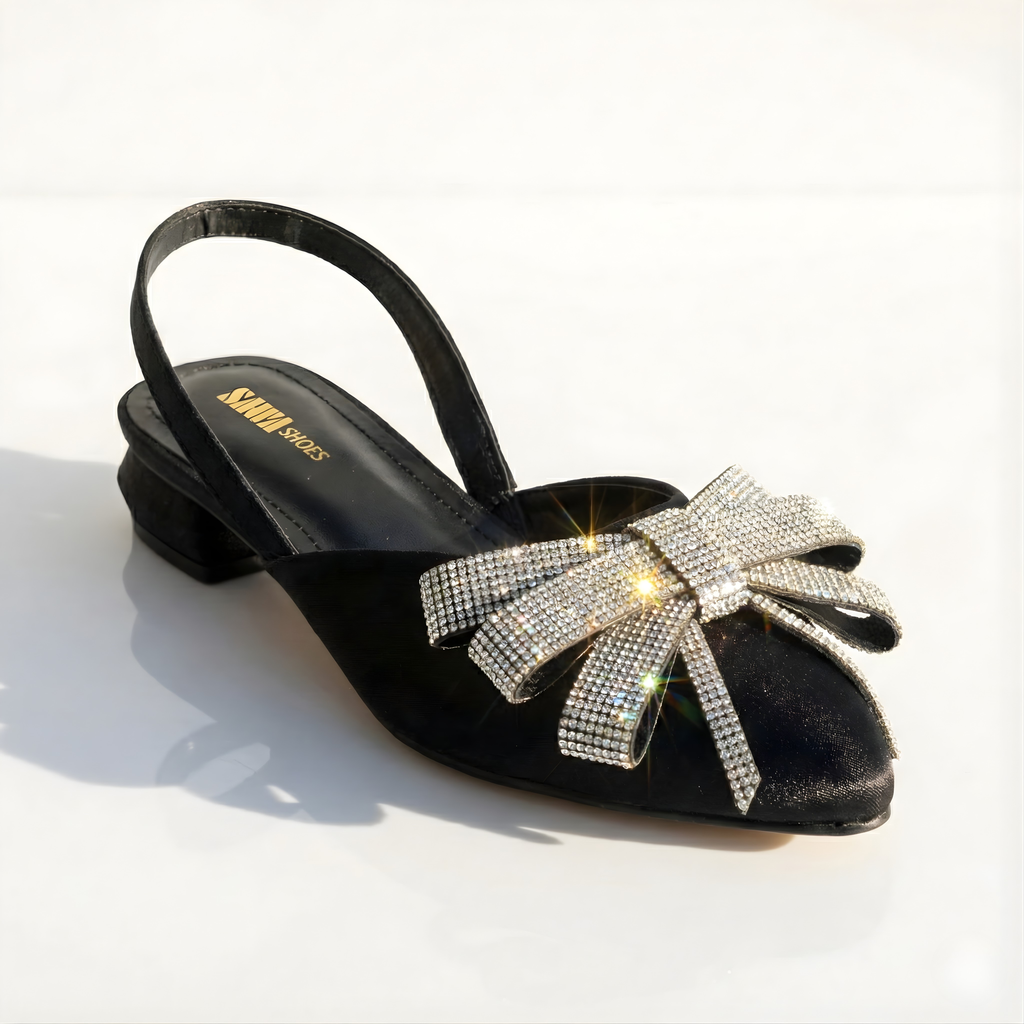 Black satin pointed-toe slingback flats with sparkling rhinestone crystal bow by SAWA Shoes