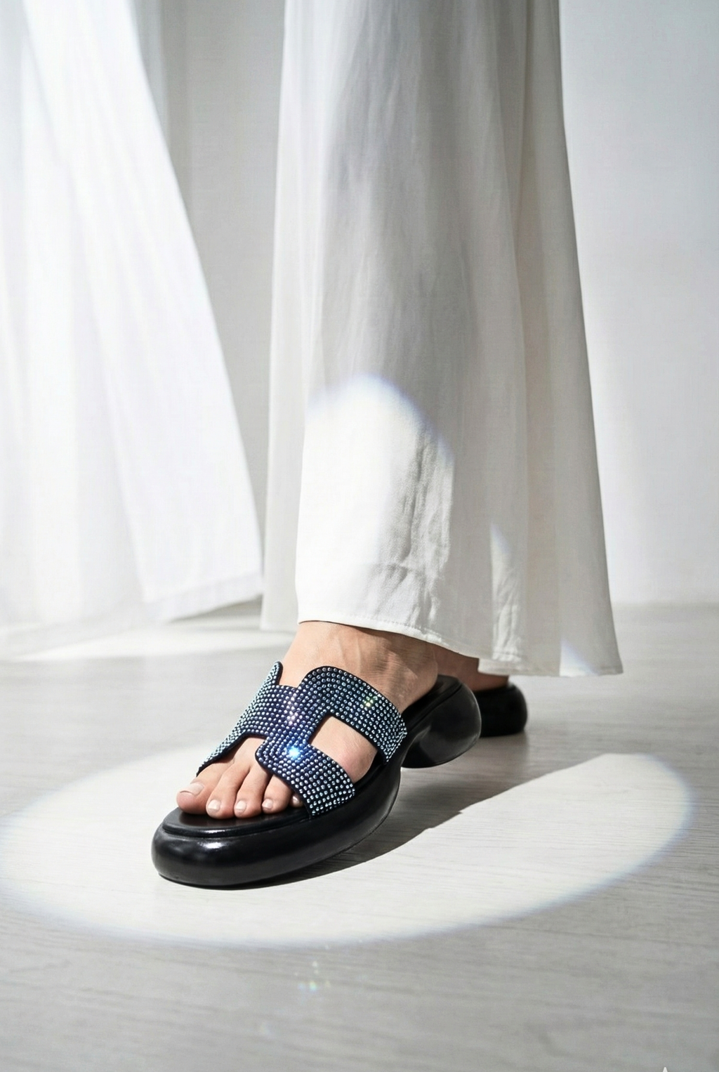 Women’s rhinestone platform sandals paired with white linen trousers – trendy summer footwear Pakistan