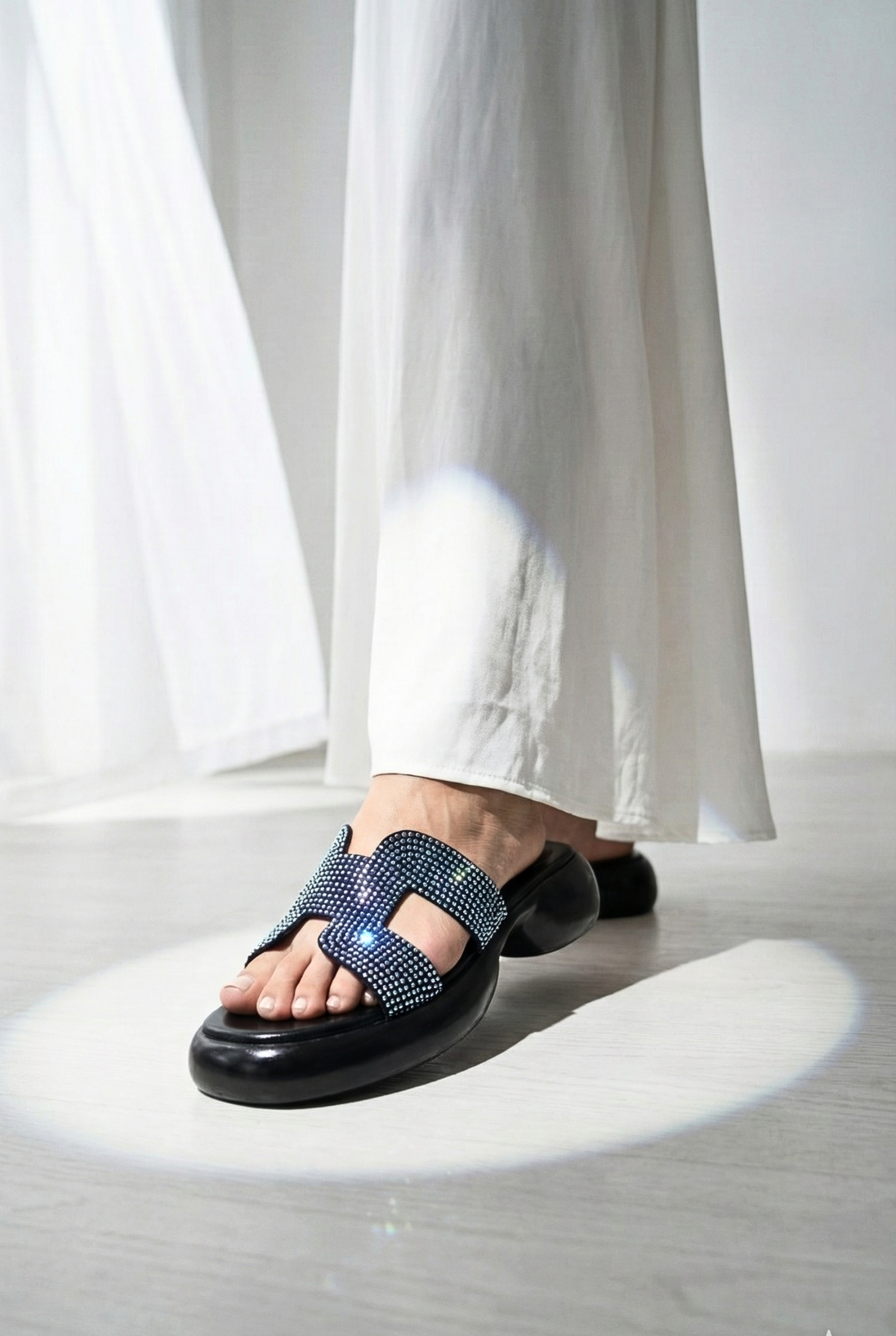 Women’s rhinestone platform sandals paired with white linen trousers – trendy summer footwear Pakistan