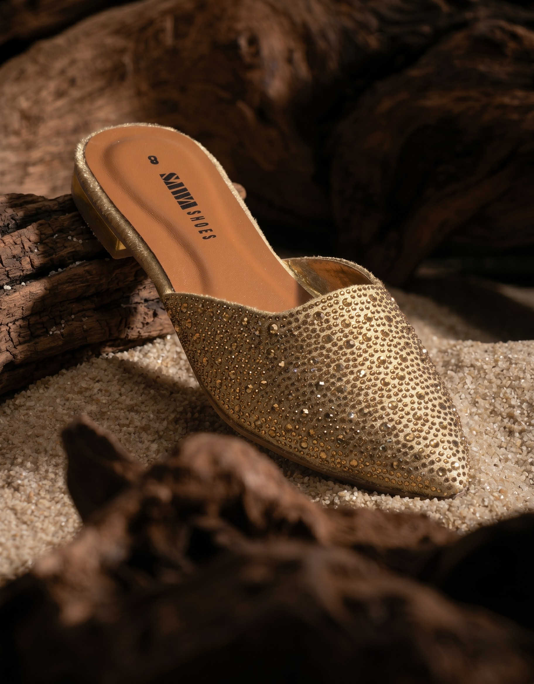 Gold glittery slipper on a textured surface