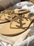 Golden leaf embellished flat sandals for women with sparkling thong strap