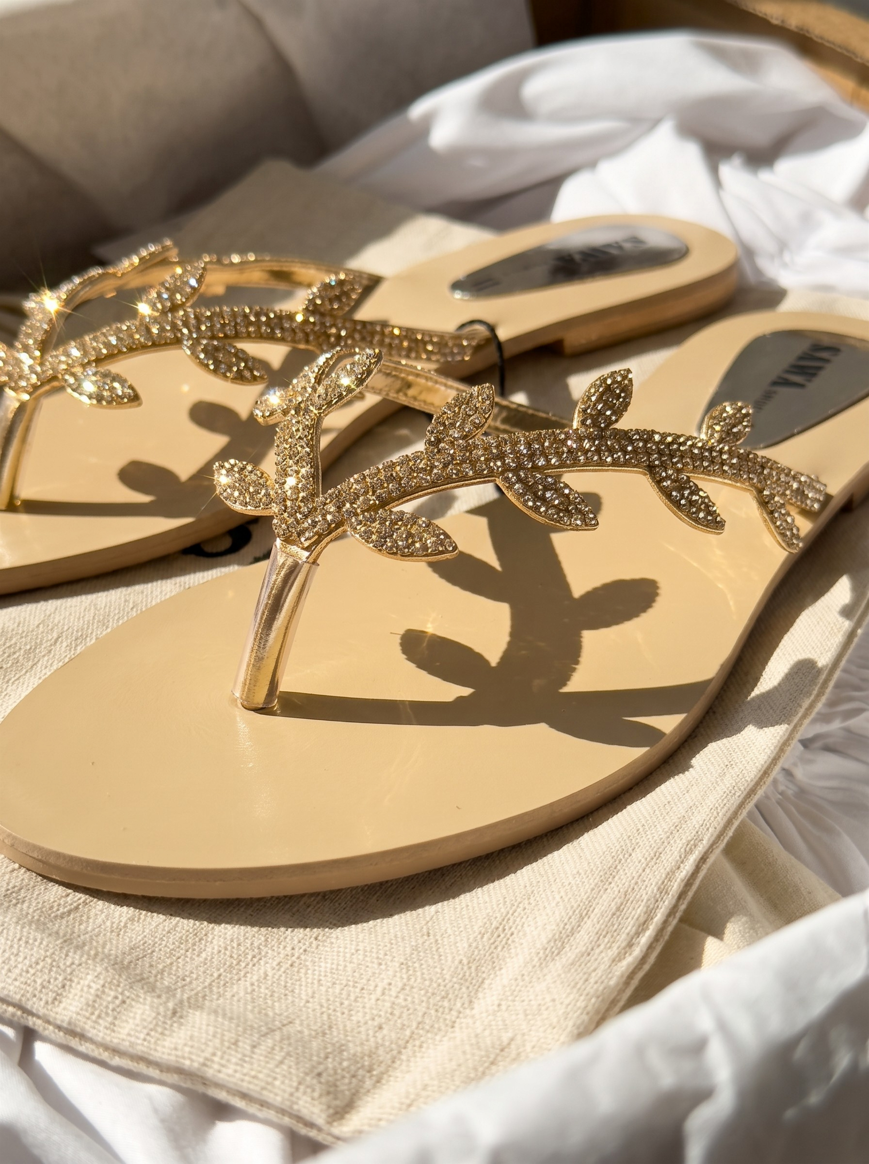 Golden leaf embellished flat sandals for women with sparkling thong strap