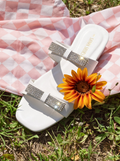 White rhinestone bow slides for women on pink picnic cloth