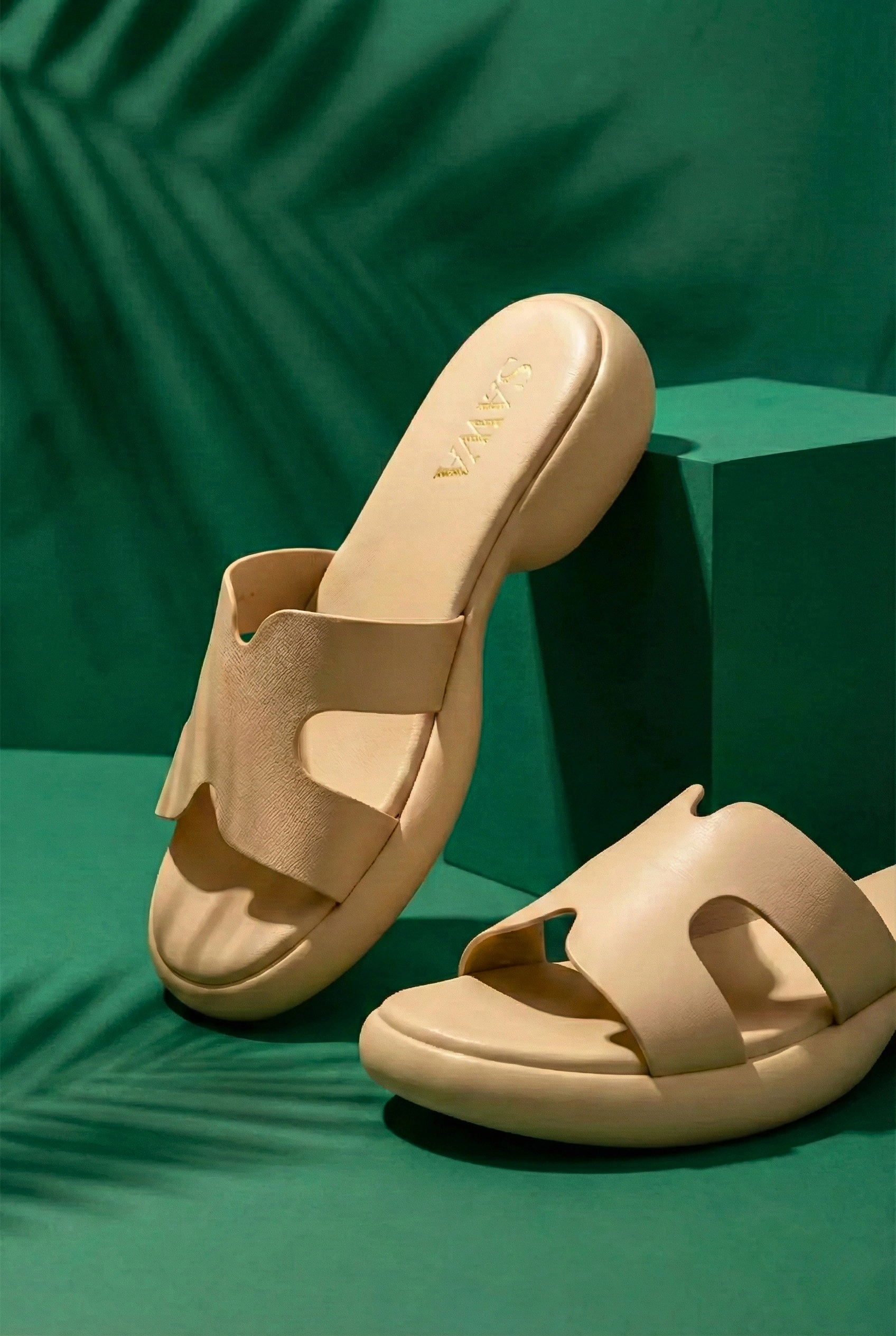 Side view of a modern women's platform sandal featuring a nude-colored minimalist strap and a chunky rounded soft sole