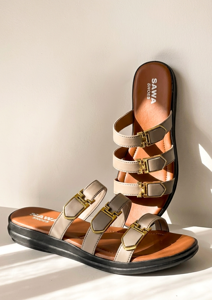 editorial product shot of taupe and cinnamon sandals against a minimalist background