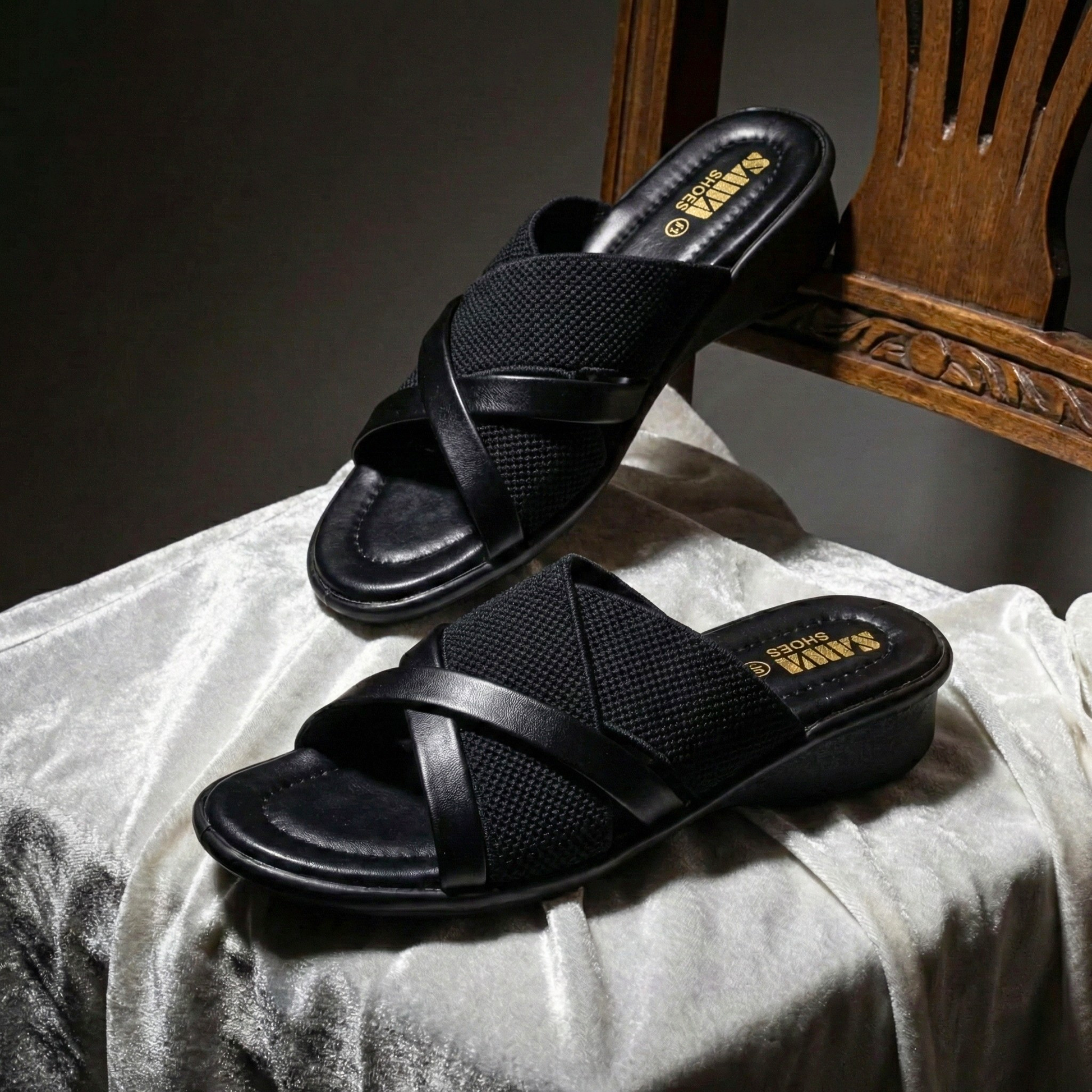 Pair of SAWA black slip-on mules for women, showcasing the stylish hybrid material and ergonomic design.