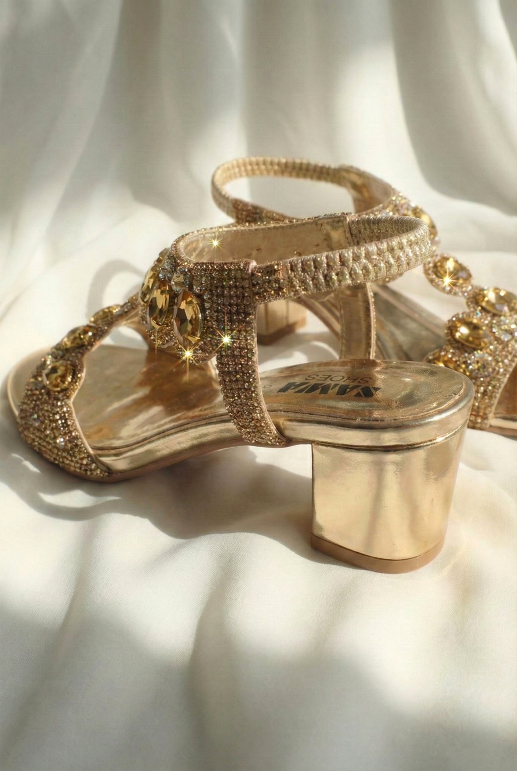 Side view of metallic gold block heel sandal featuring rhinestone straps and comfortable 2-inch heel for bridal wear.