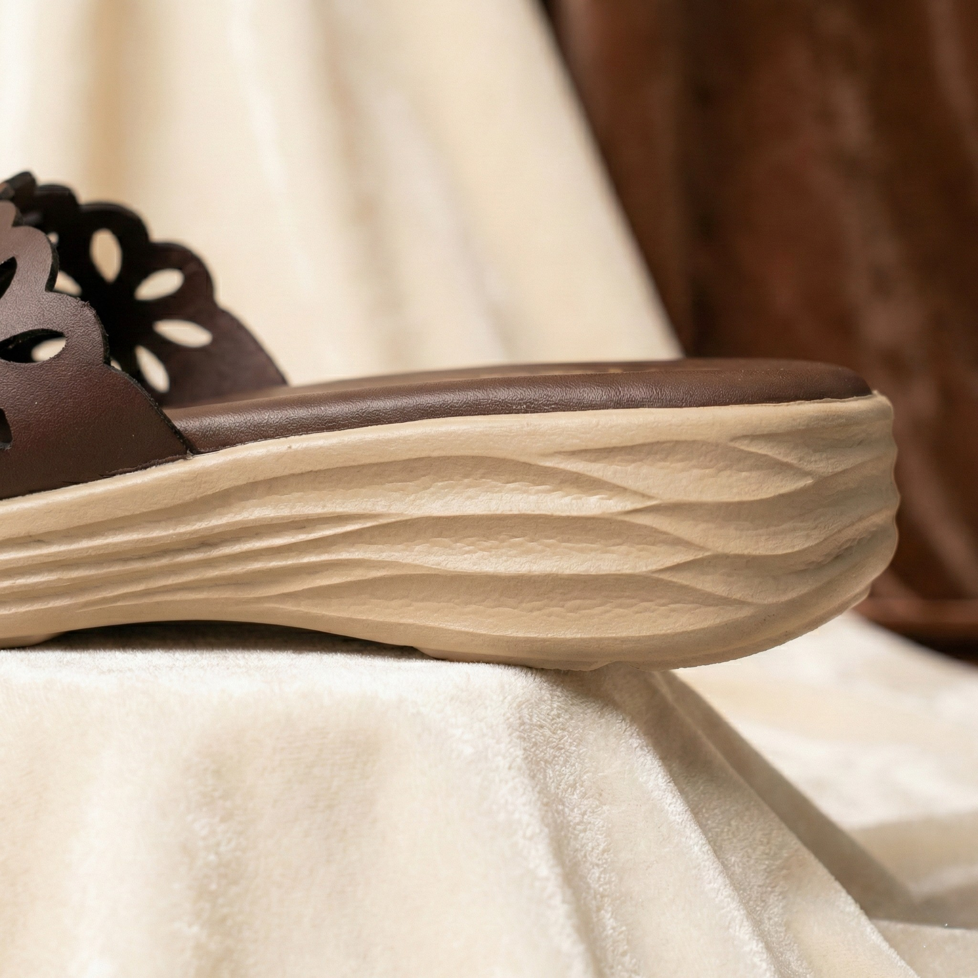 Lightweight cocoa and cream chappal for ladies featuring a shock-absorbing wavy sole and elegant floral design