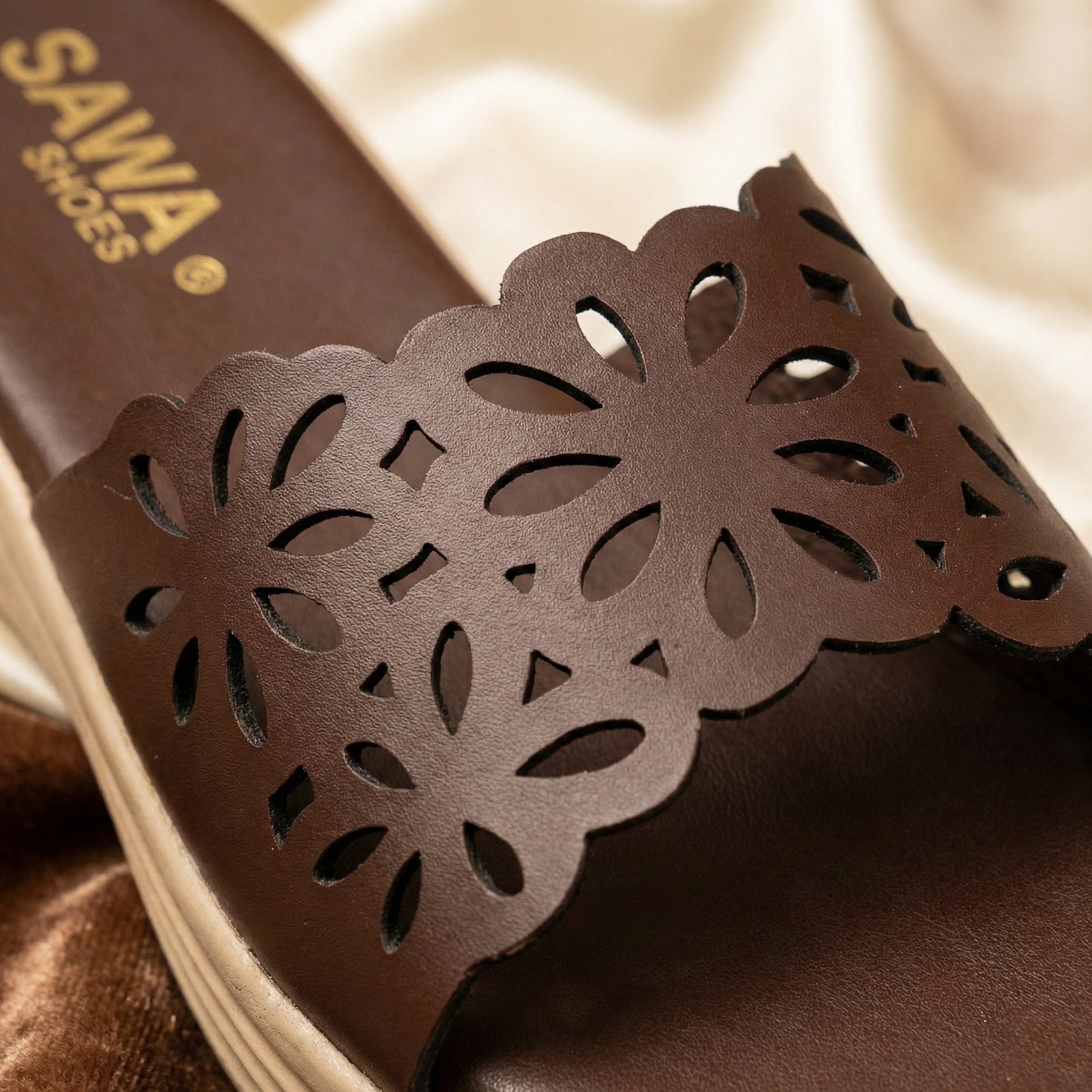 Premium Sawa Shoes cocoa comfort slides with metallic gold branding and intricate floral laser-cut detailing