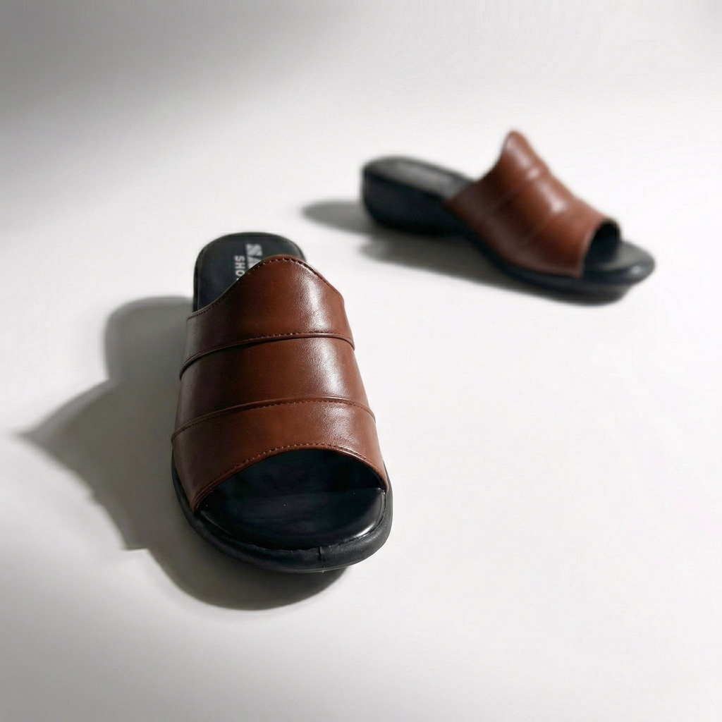 Mahogany-colored wide-strap wedge mules with a black sole and triple-stitch detailing, shown on a clean white background.