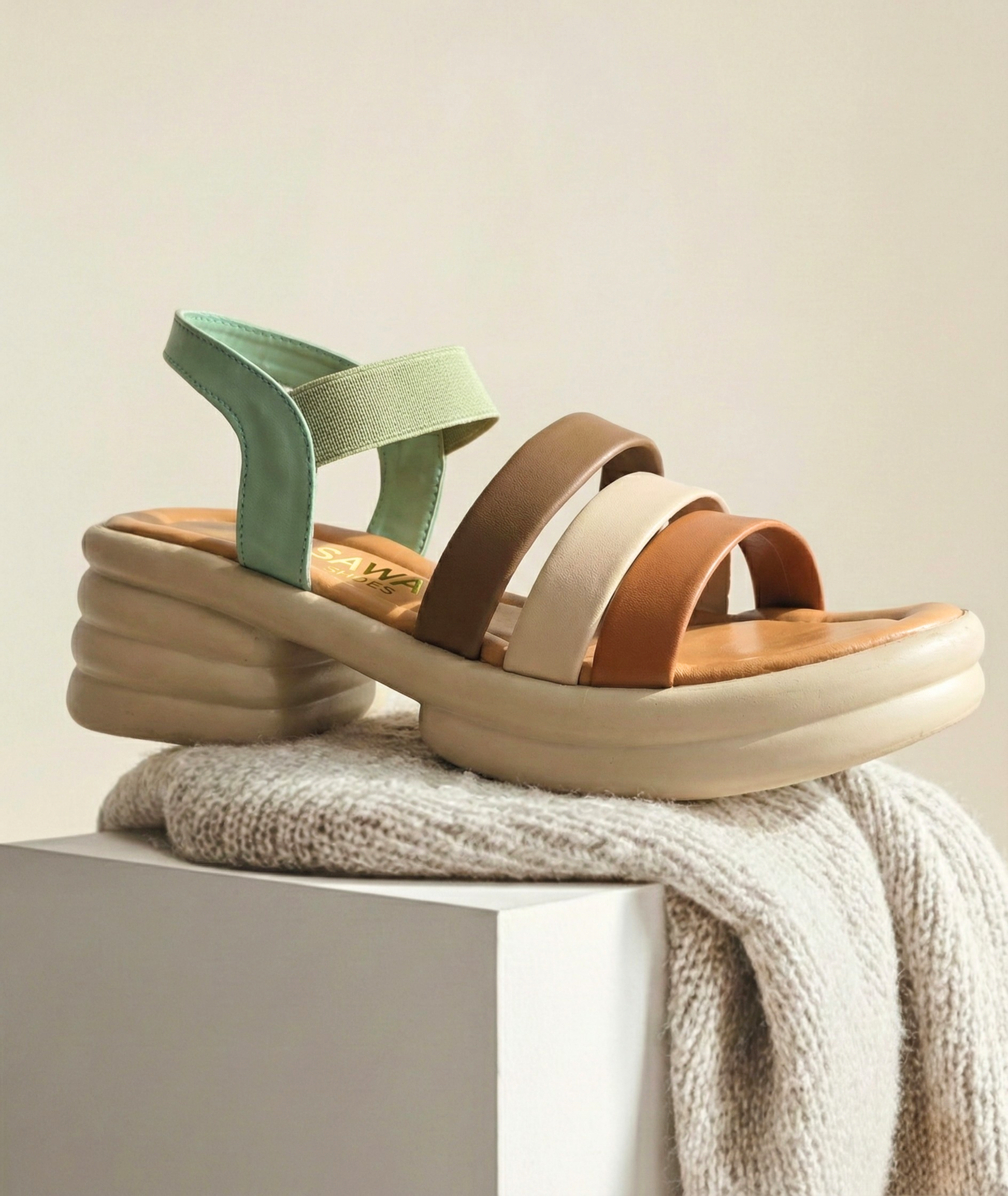 Close-up of the lightweight ergonomic "bubble" sole and elasticized sage green back strap of the sawa.pk platform sandal