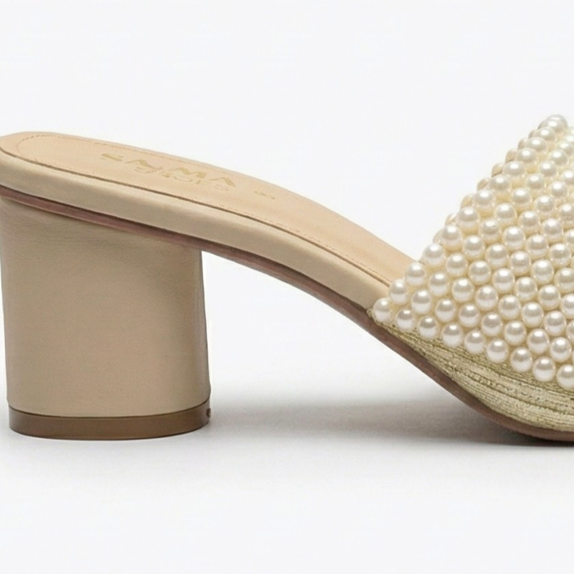Beige sandal with pearl embellishments on a white background